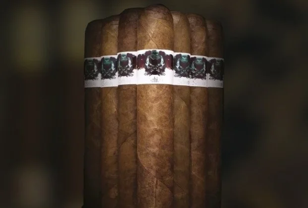 Close-up of a bunch of cigars with a band around them showcasing a portrait of a person.