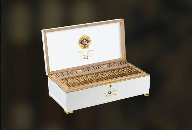 Open white box with gold coins inside, celebrating 130th anniversary.