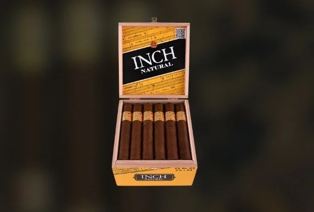 Open cigar box with six cigars inside and a ruler design on the inside lid with the text "INCH NATURAL".