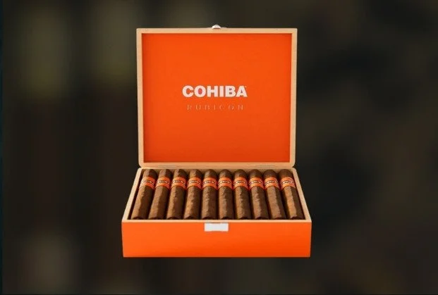 Open orange box with cigars inside and 'COHIBA' branding on the inside of the lid.