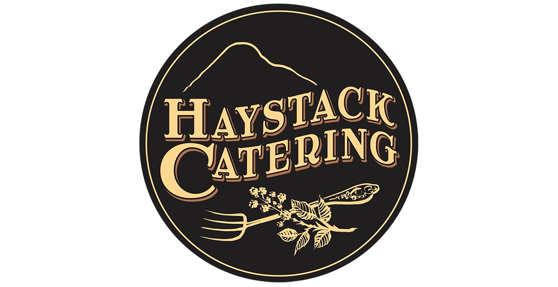 Logo for Haystack Catering featuring a mountain outline, a fork with herbs and leaves, and vintage-style text.