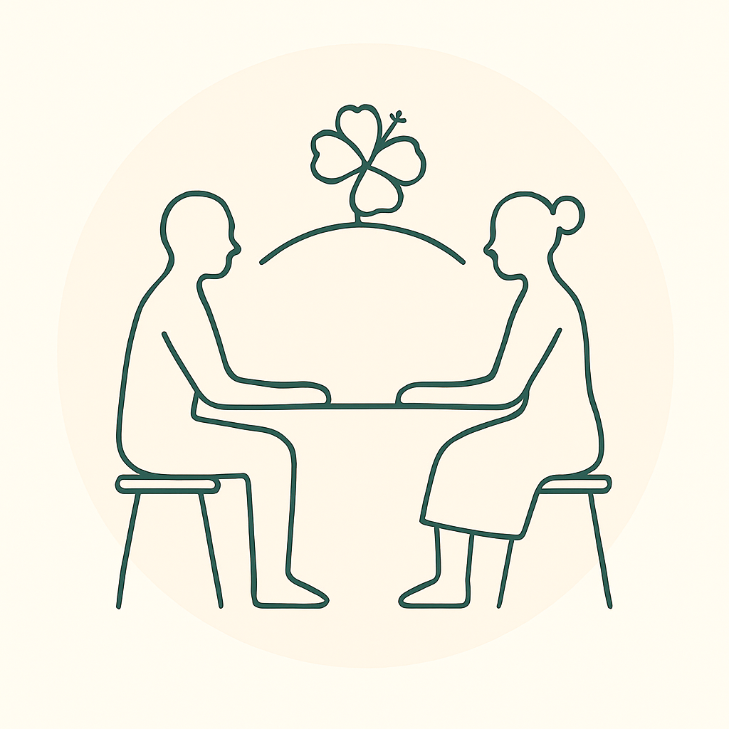 Line drawing of a man and woman sitting across from each other at a table with a four-leaf clover in the background.