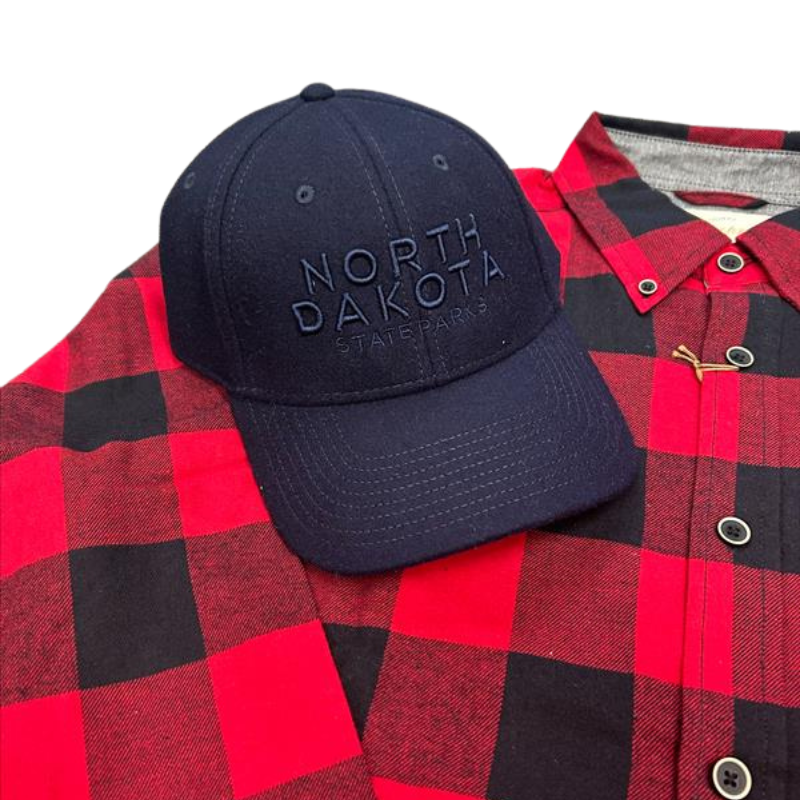 Close up of red plaid flannel and black hat bundle