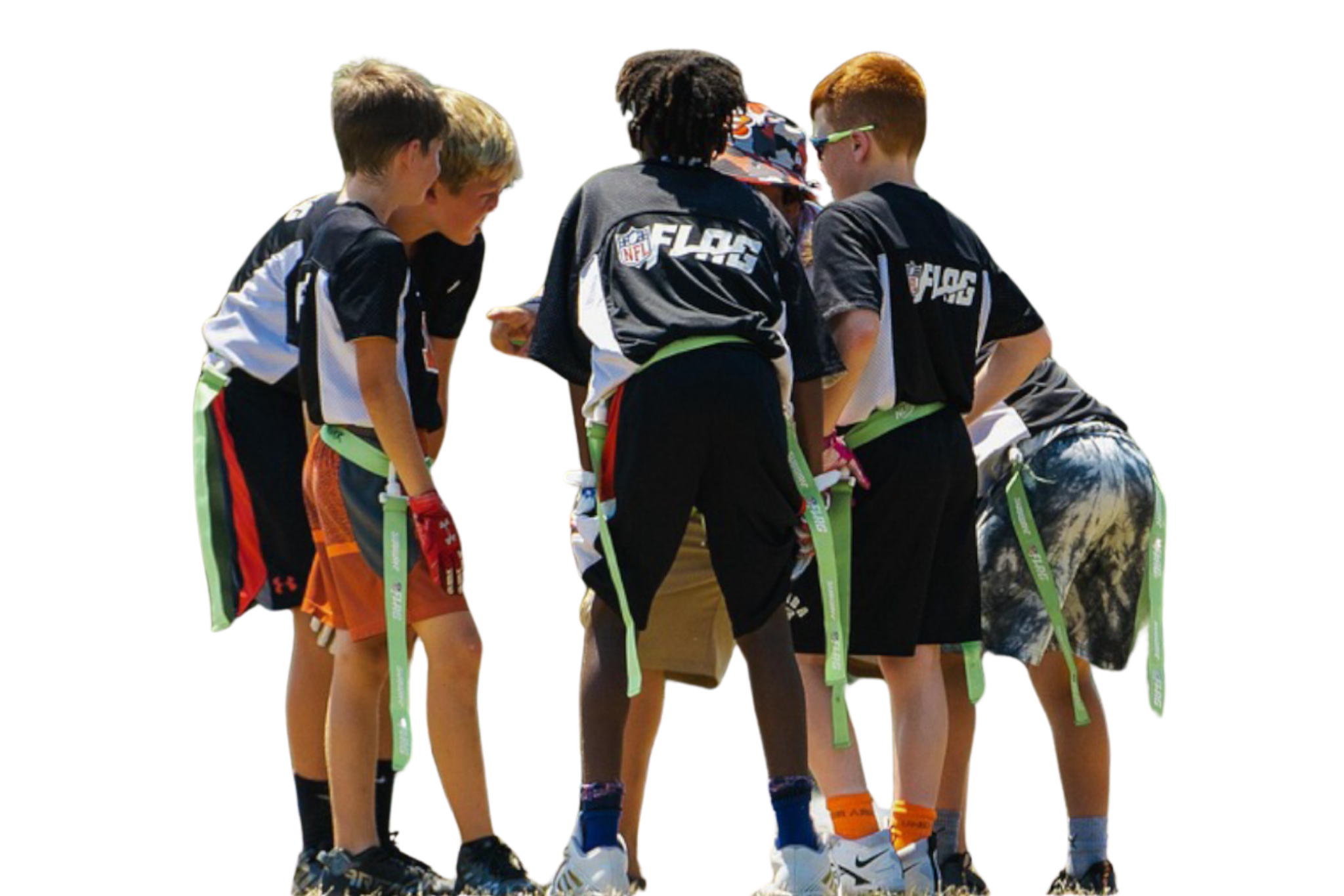 A group of young boys gathered together outdoors, wearing sports jerseys and shorts in a huddle.