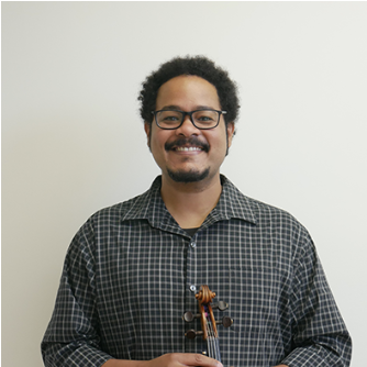 Man with glasses smiling, holding a violin against a plain light background