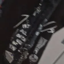 A collection of black spray paint cans positioned vertically.