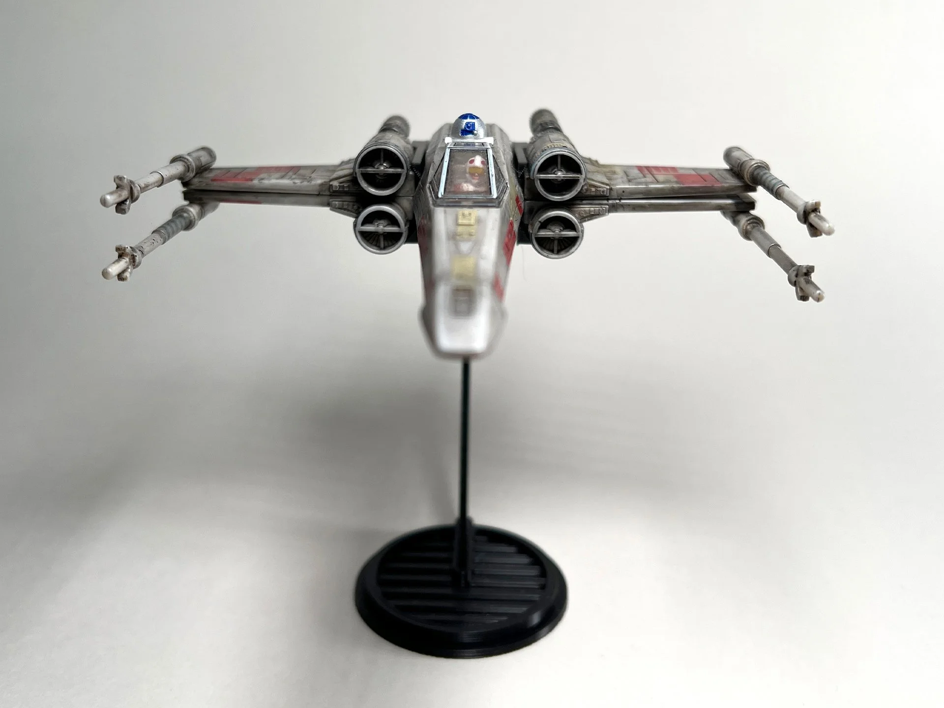 X-Wing Flight Stand (Closed Wings) from the Micro Galaxy Squadron series, positioned on a modern black stand with a plain background, perfect for Star Wars collectors and enthusiasts.