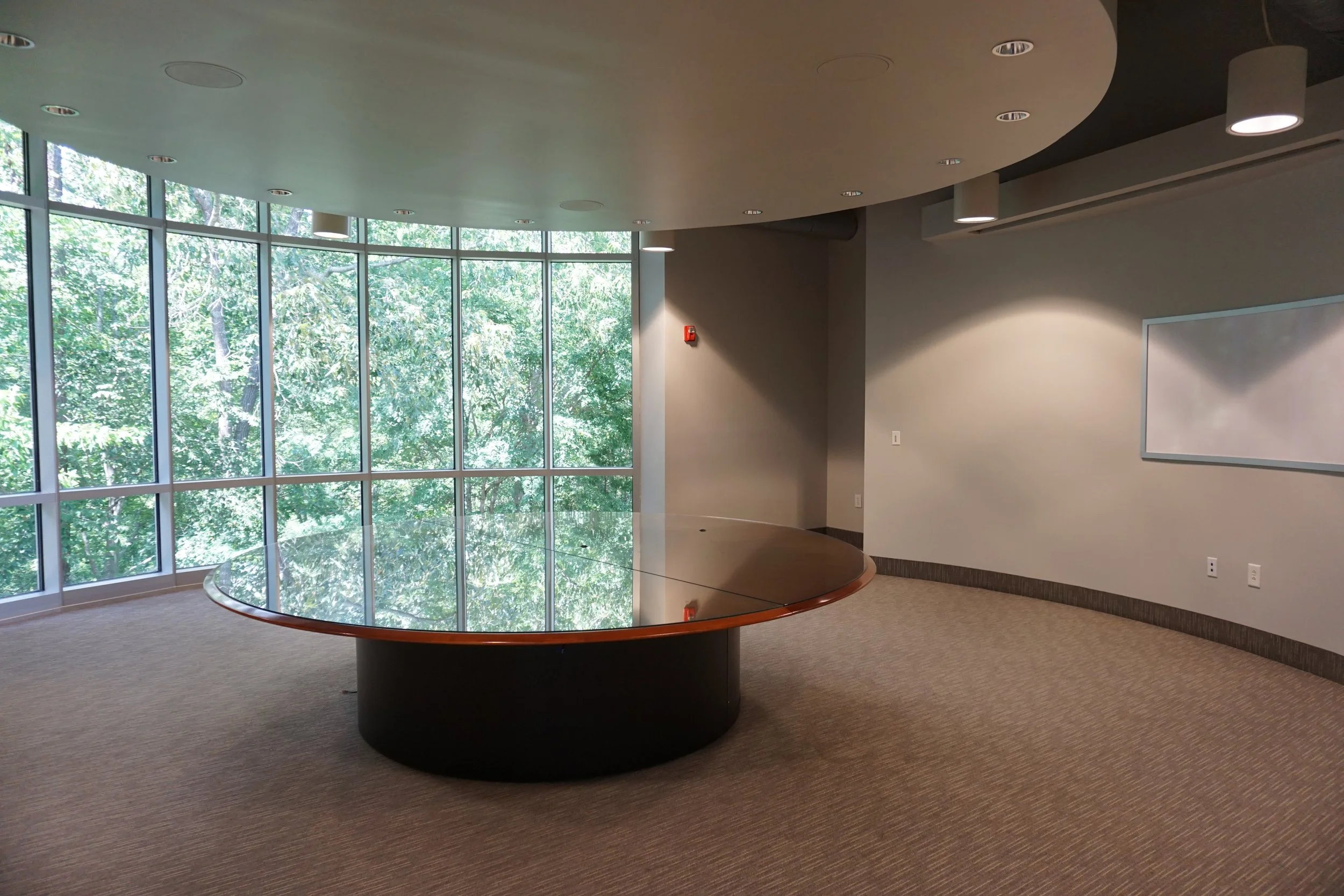 Large meeting room with floor-to-ceiling windows and circular table