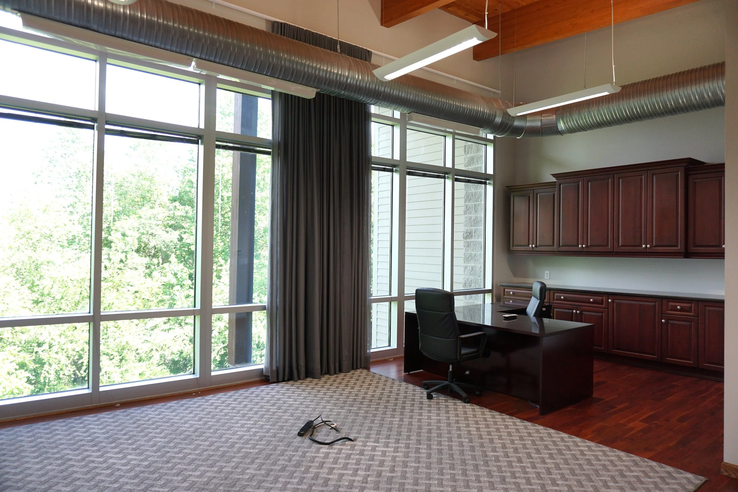 Executive Suite office space available for lease in Raleigh with lounge area, desk, private bathroom, and dedicated mailbox.