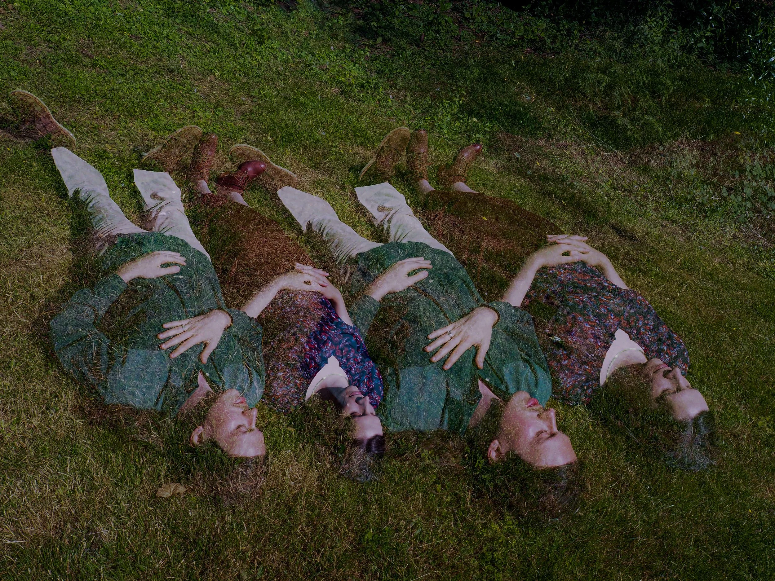 A double exposure image of Sister Sigh laying in a grass field.