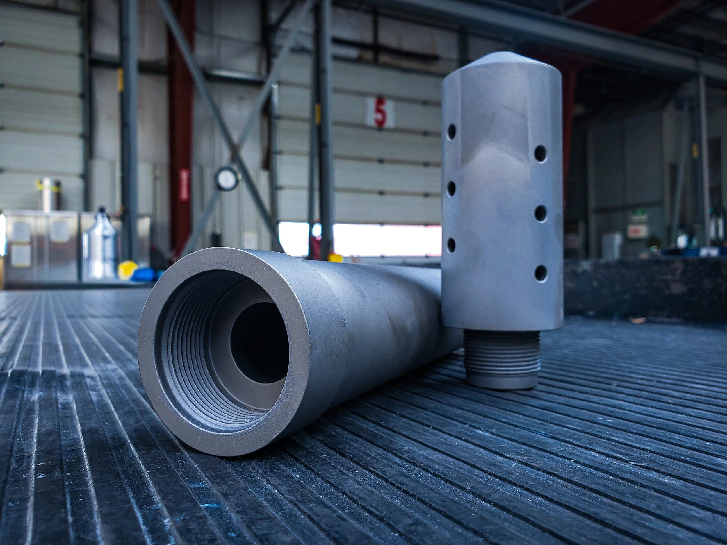 Close-up of two metallic mechanical parts that have been boronized by Custom Coatings International.