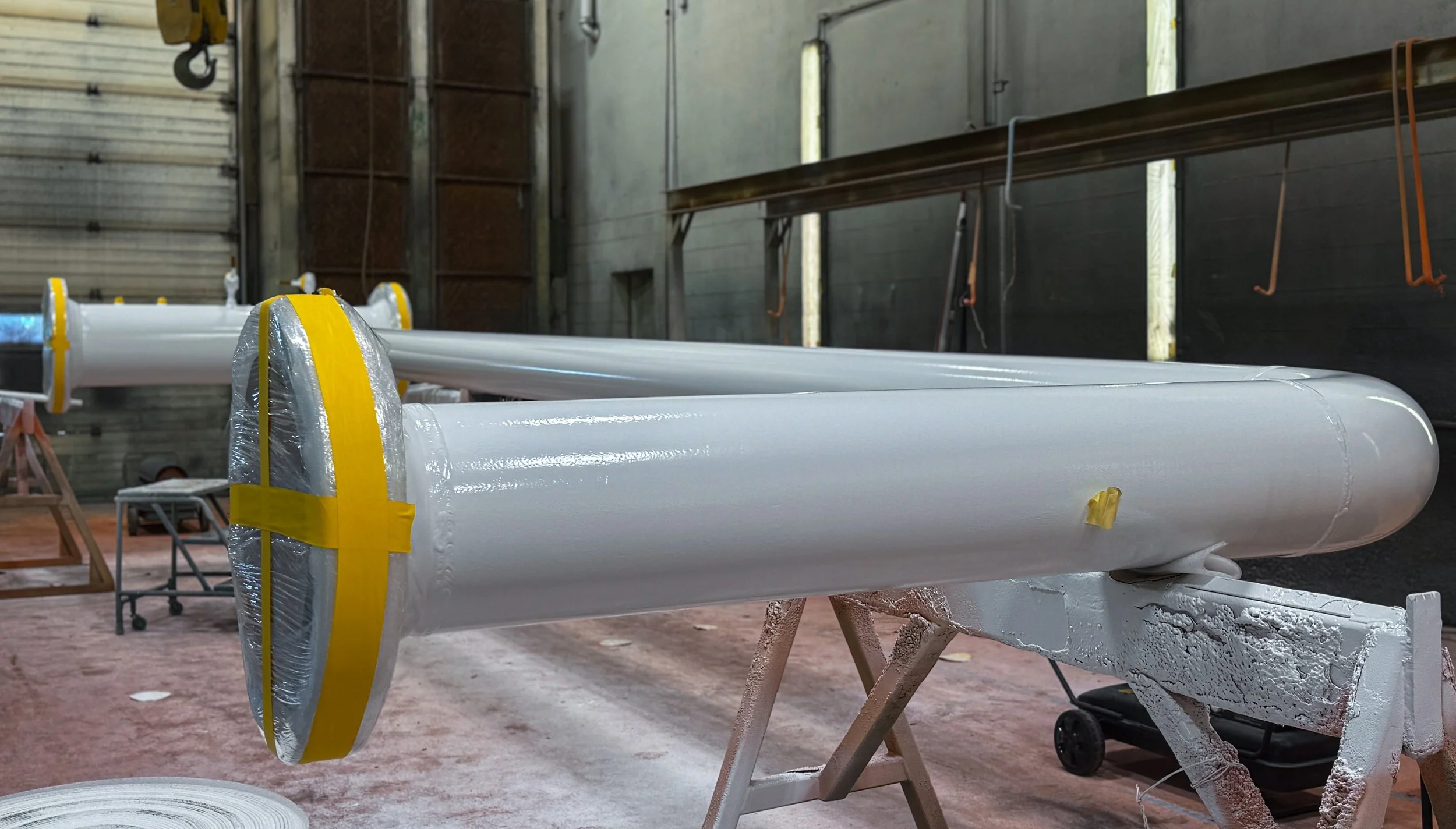 Large white cylindrical pipe with an epoxy and polyurethane paint system.