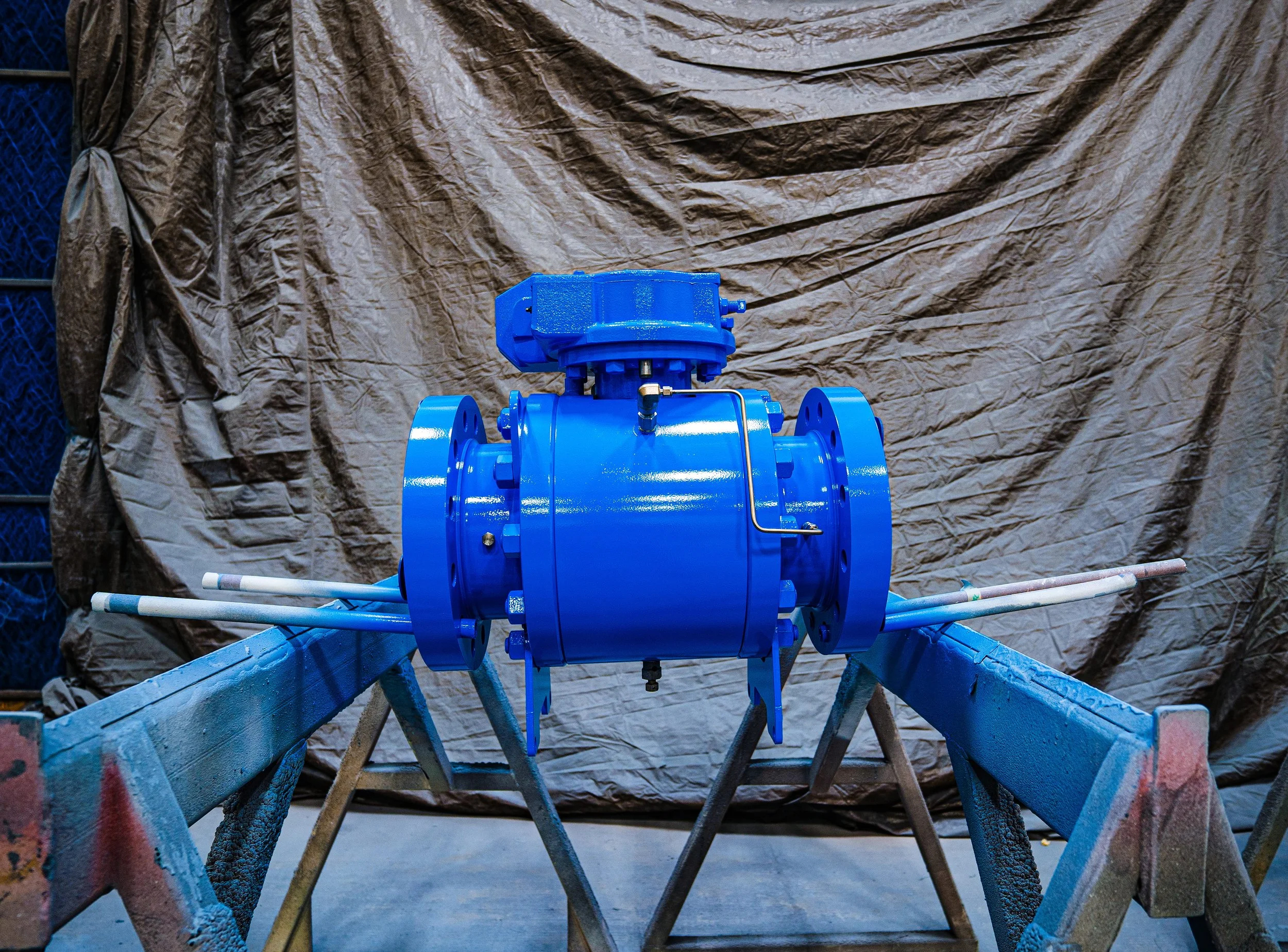 A large blue industrial valve for oil and gas showing custom coatings international's industrial painting work, available in shop in Leduc, Alberta, Canada.