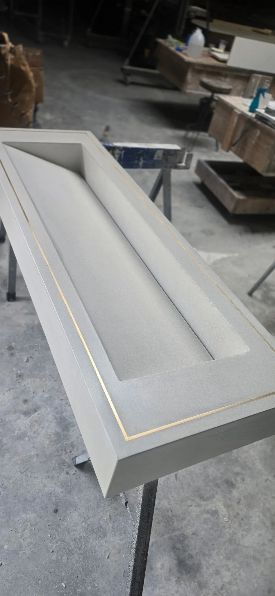 Brass inlay white concrete sink with slot drain