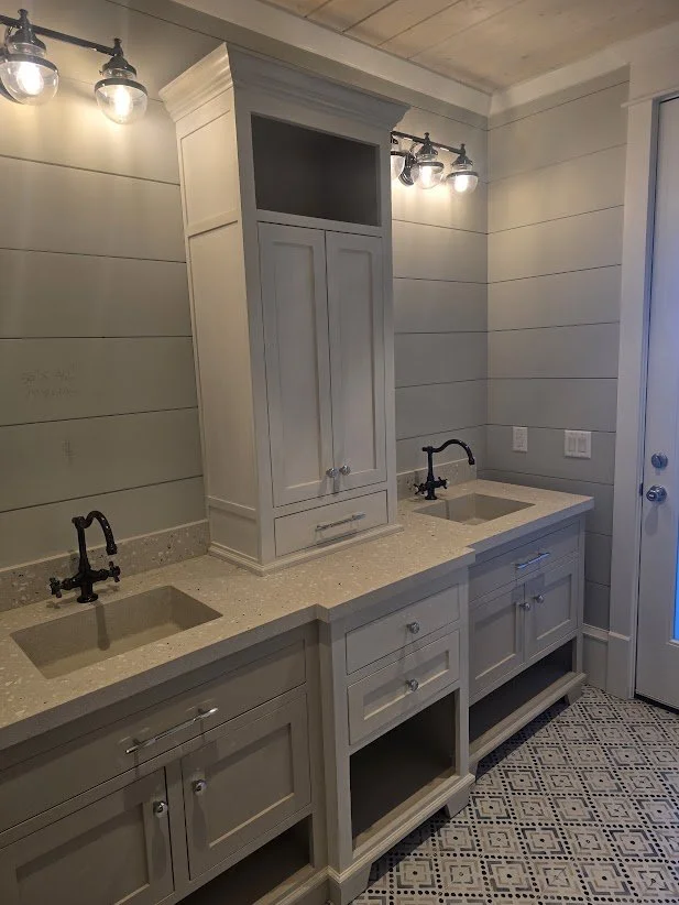 Double vanity with two integral concrete sinks, exposed shell and shaped countertop edges