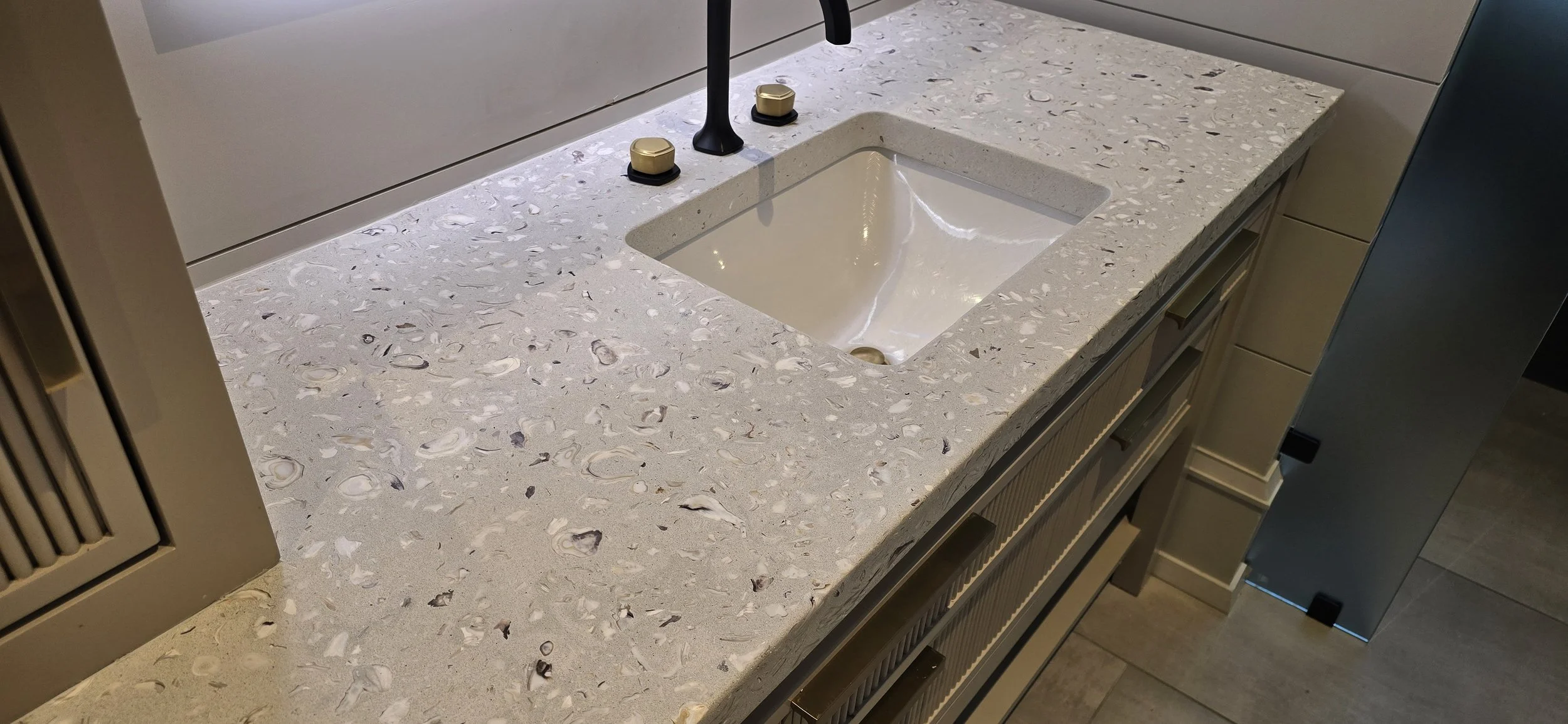 Old Town Tabby Shellstone vanity top with exposed oyster shell around an undermount basin