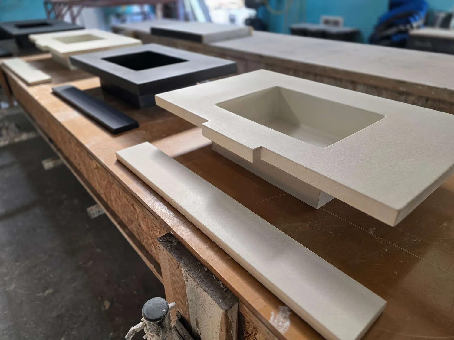 Custom integral concrete sinks and backsplash pieces on the workbench in the Calhoun studio