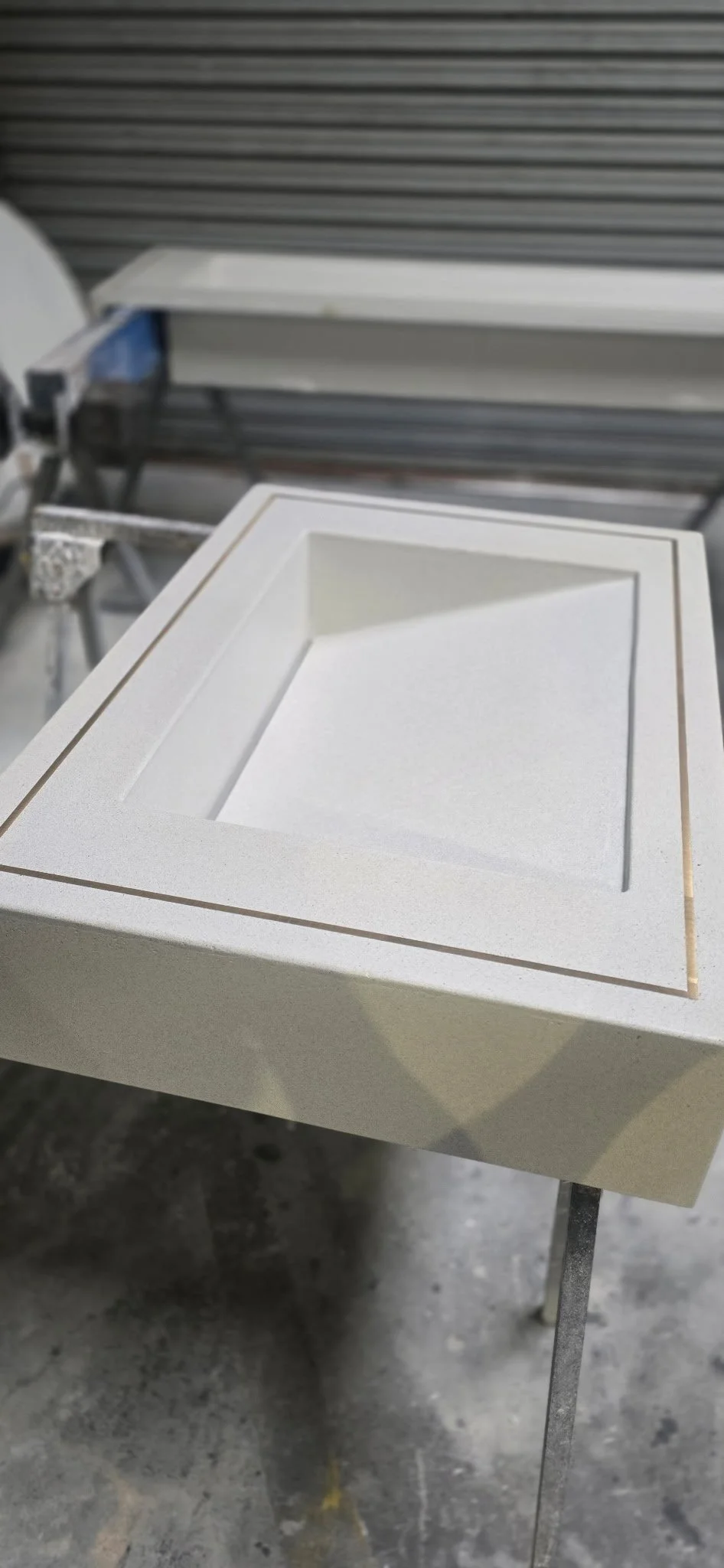 Brass inlay white concrete sink