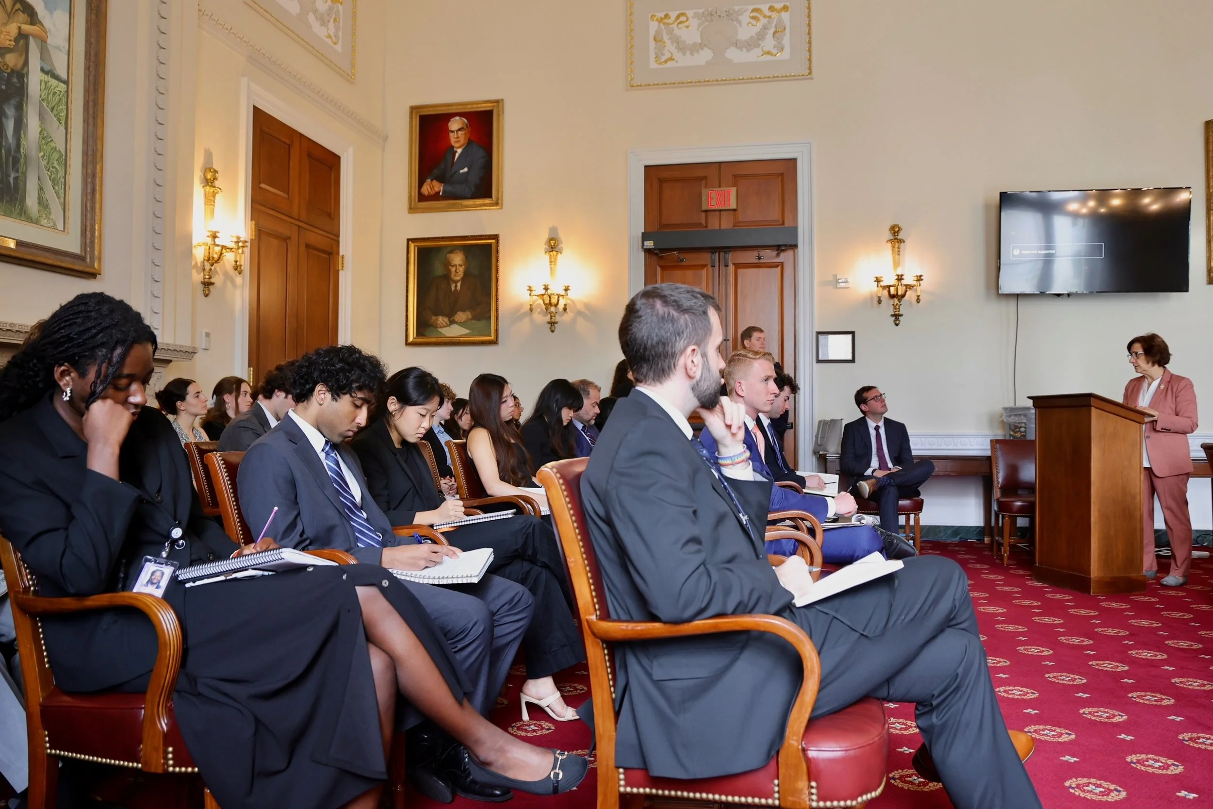  Congressional staffers and guests listen attentively during the briefing.  