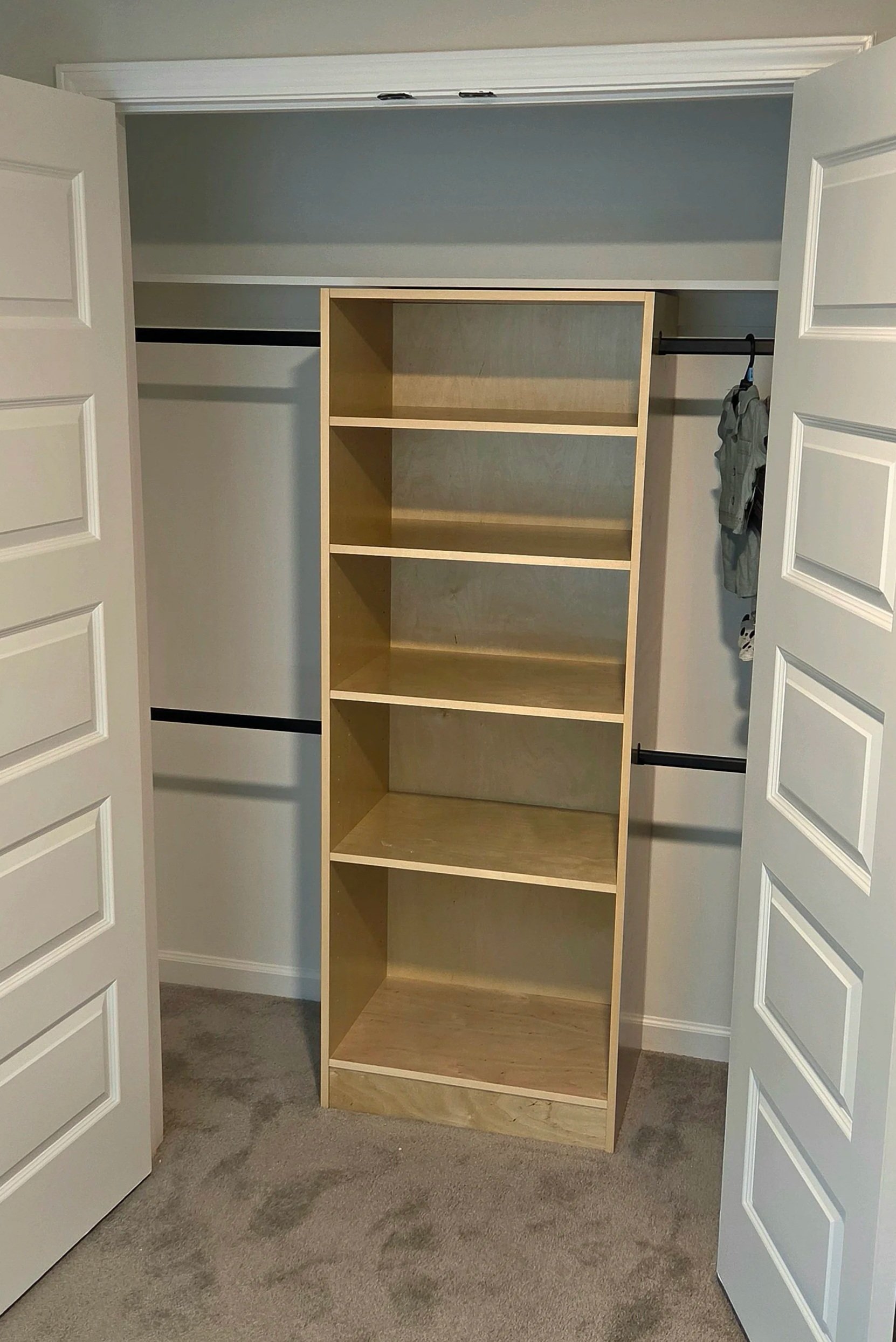 Custom closet with shelving and hanging clothes