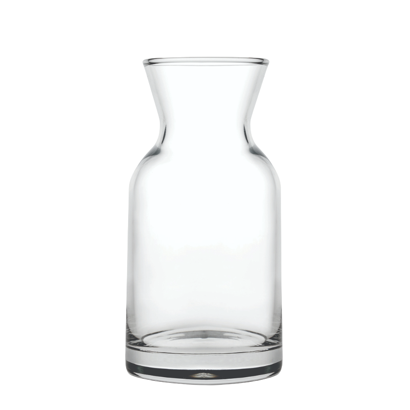 A clear glass bottle with a narrow neck and a wide base, empty and transparent.