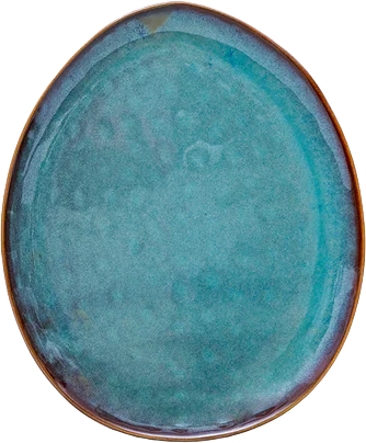 A teal blue oval ceramic plate with a brown rim.