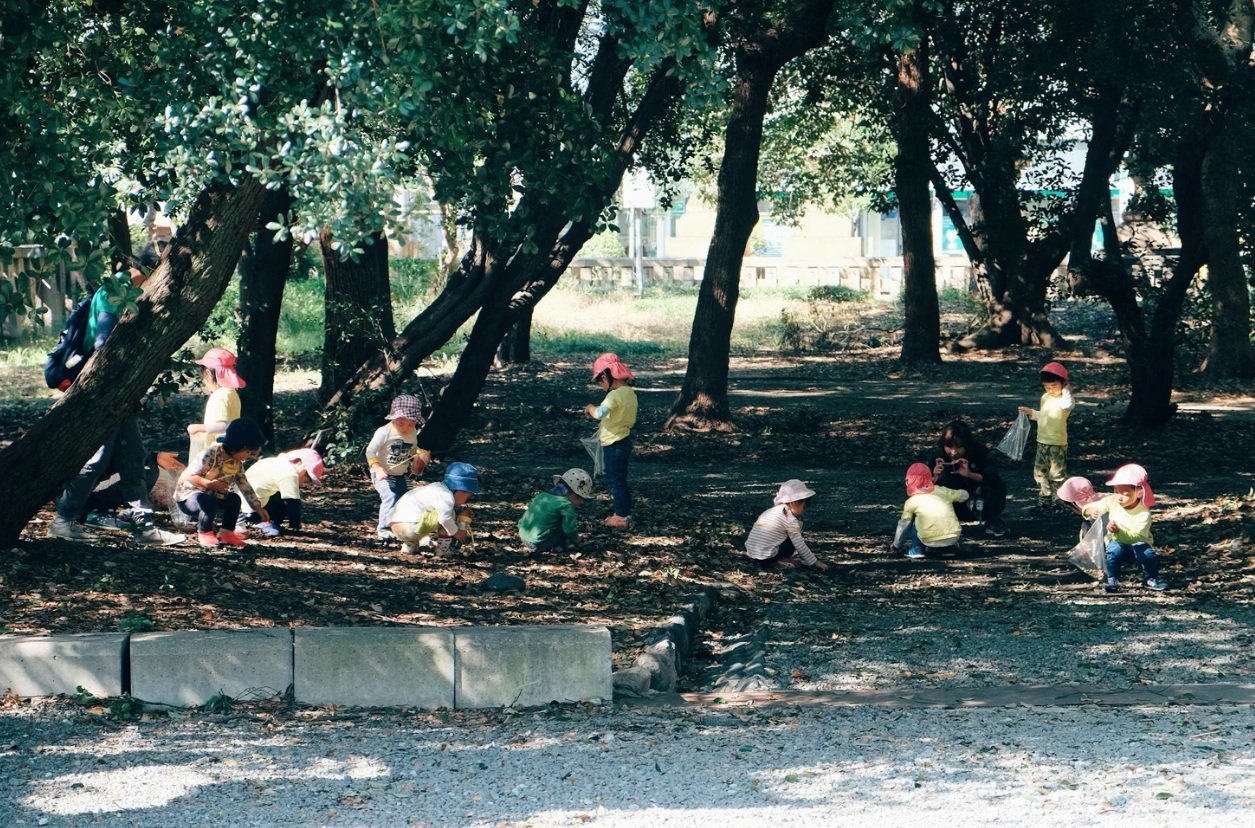Children taking part in forest school outdoor learning UK woodland setting
