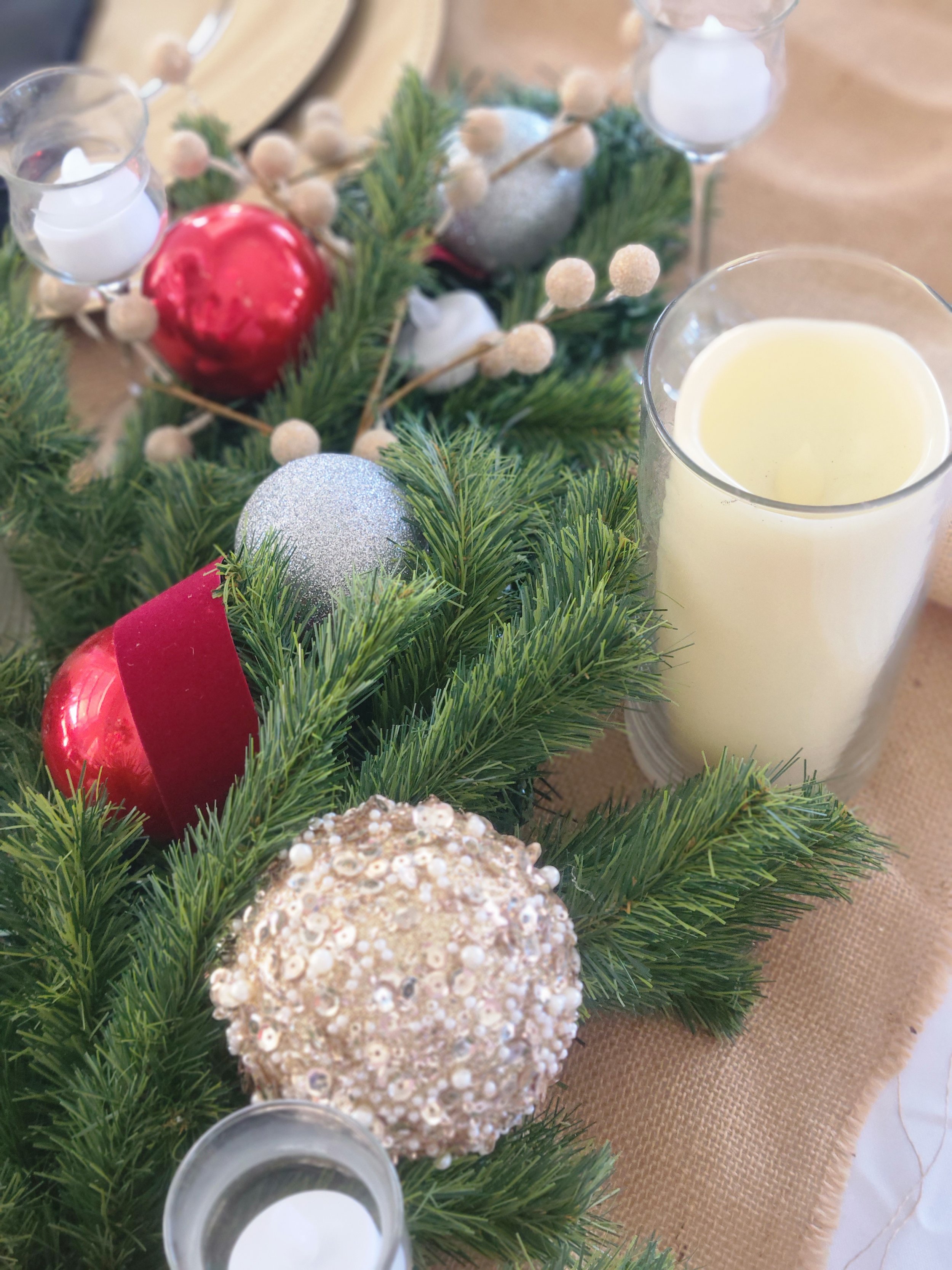 Christmas theme wedding table decor wine glass pine tree clippings candles ornaments flameless candles glitter balls gold charger plates tan table cloth owensboro kentucky gold floral pieces