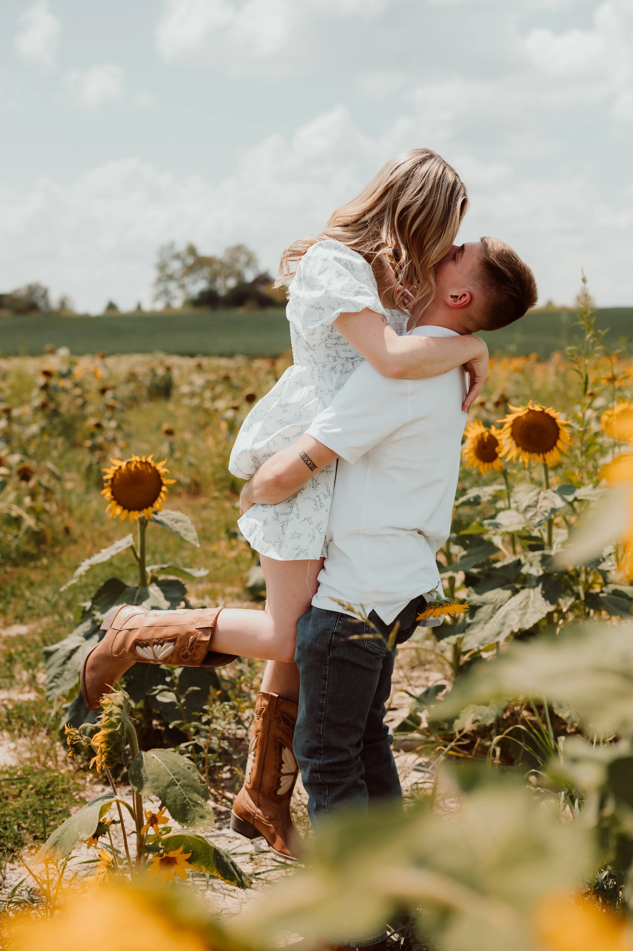 Owensboro KY engaged couple enjoying intentional quality time Engagement photo session in a sunflower field
