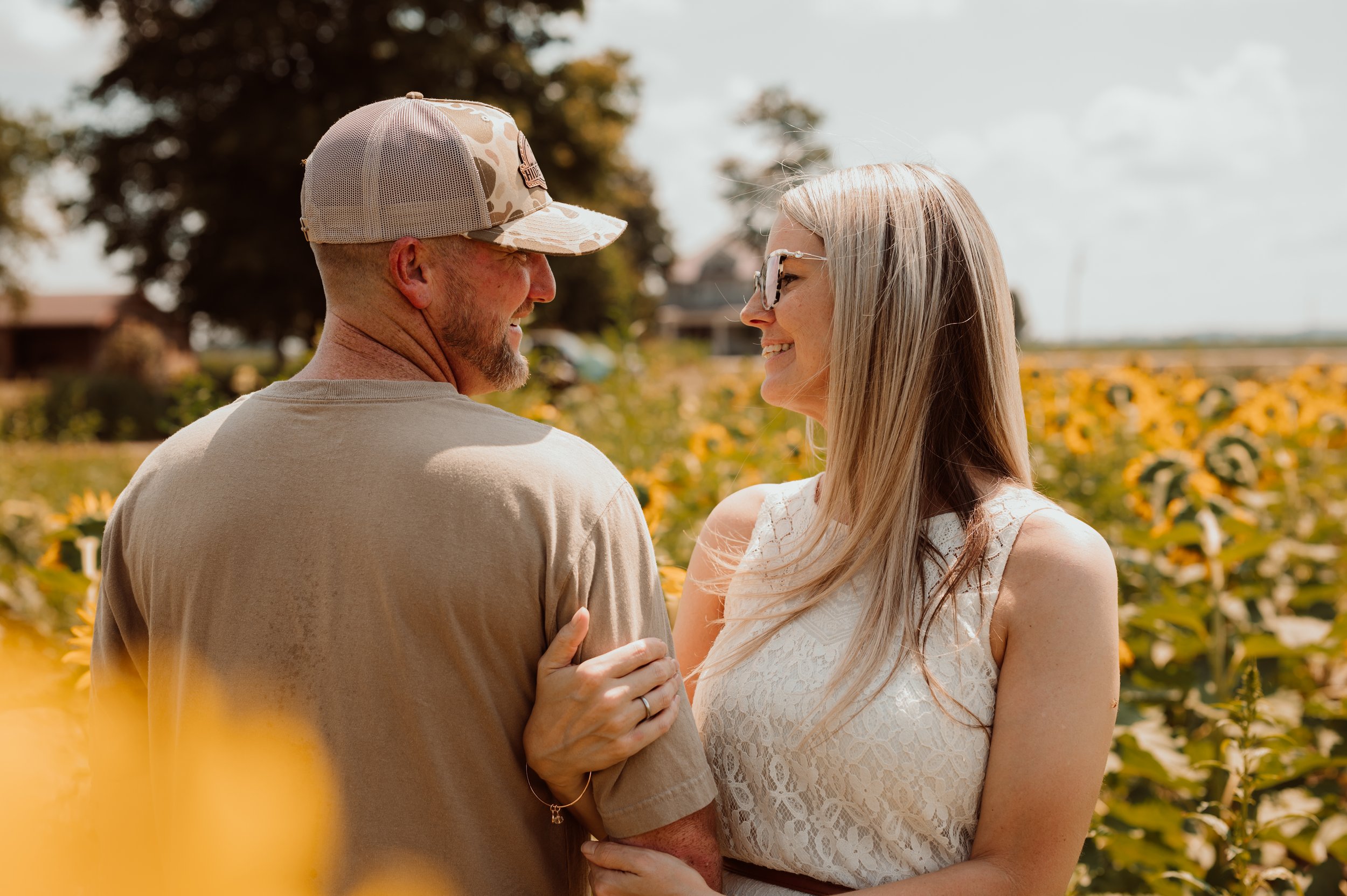 Holiday season engagement memories engagement photos in a locally owned sunflower field