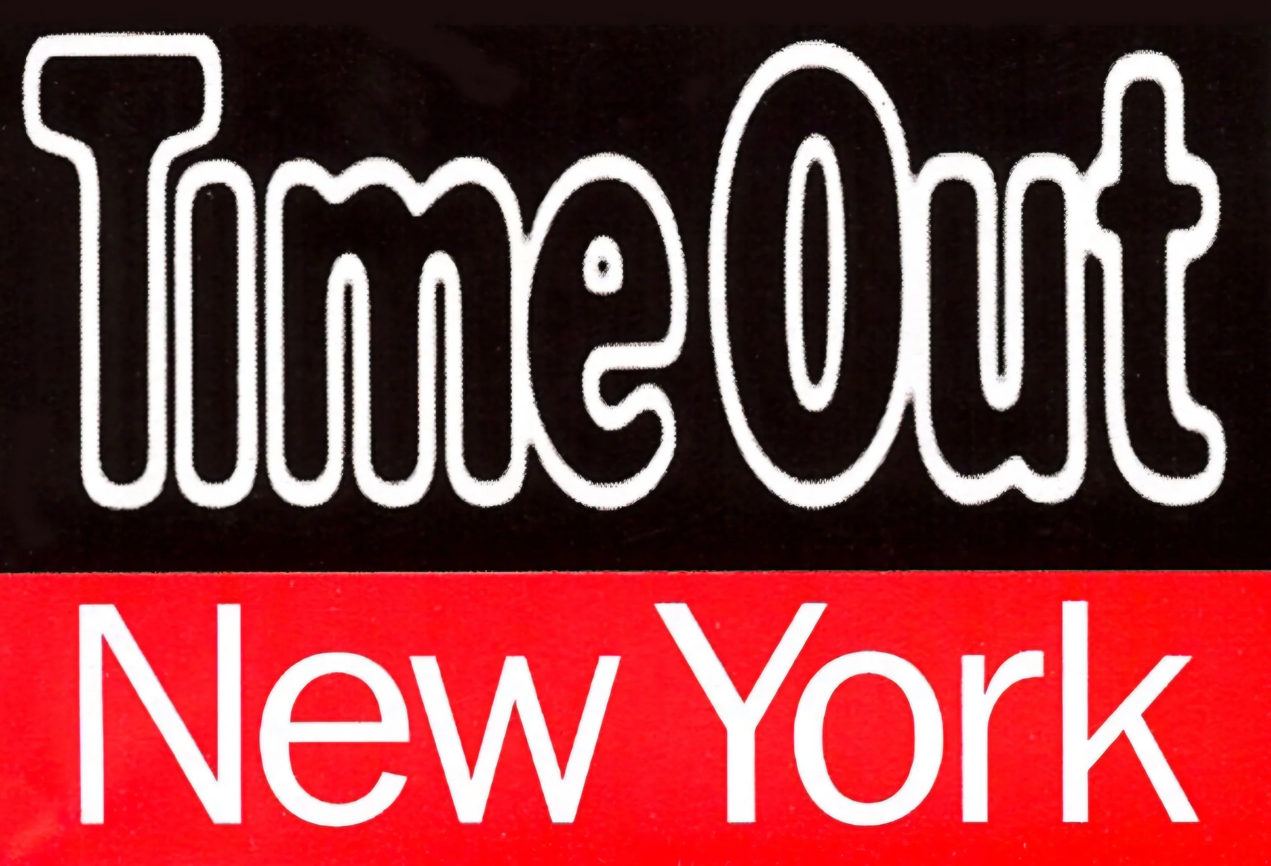 A sign with the text 'Timelout' in large white letters on a black background, and 'New York' in white letters on a red background below.