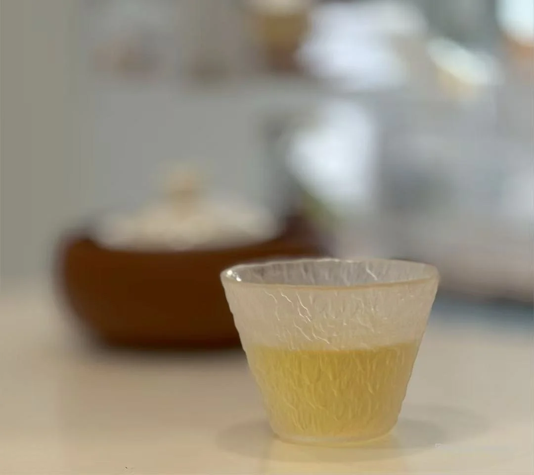 Golded honeydew oolong  tea liquid in glass, a soft translucent golden color