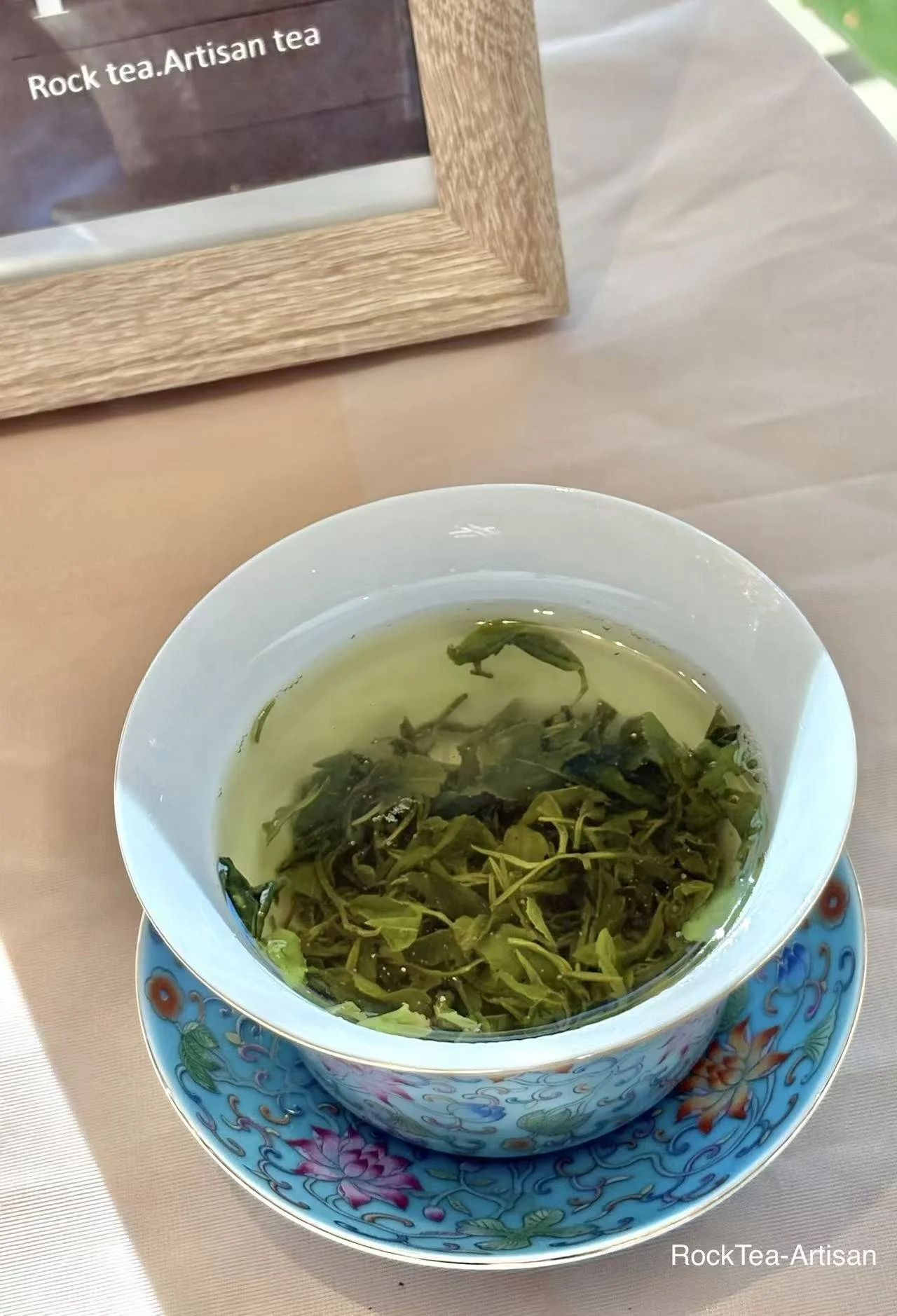 Bright warm‑green infusion of current‑harvest Tai Mount Daughter green tea  has a luminous liquor with chestnut‑aroma .