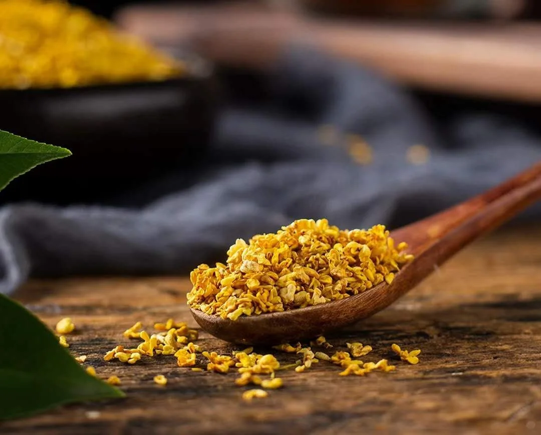 Premium Grade 1 Golden Osmanthus flower tea in a wooden spoon, 100% natural and harvested from Guilin.