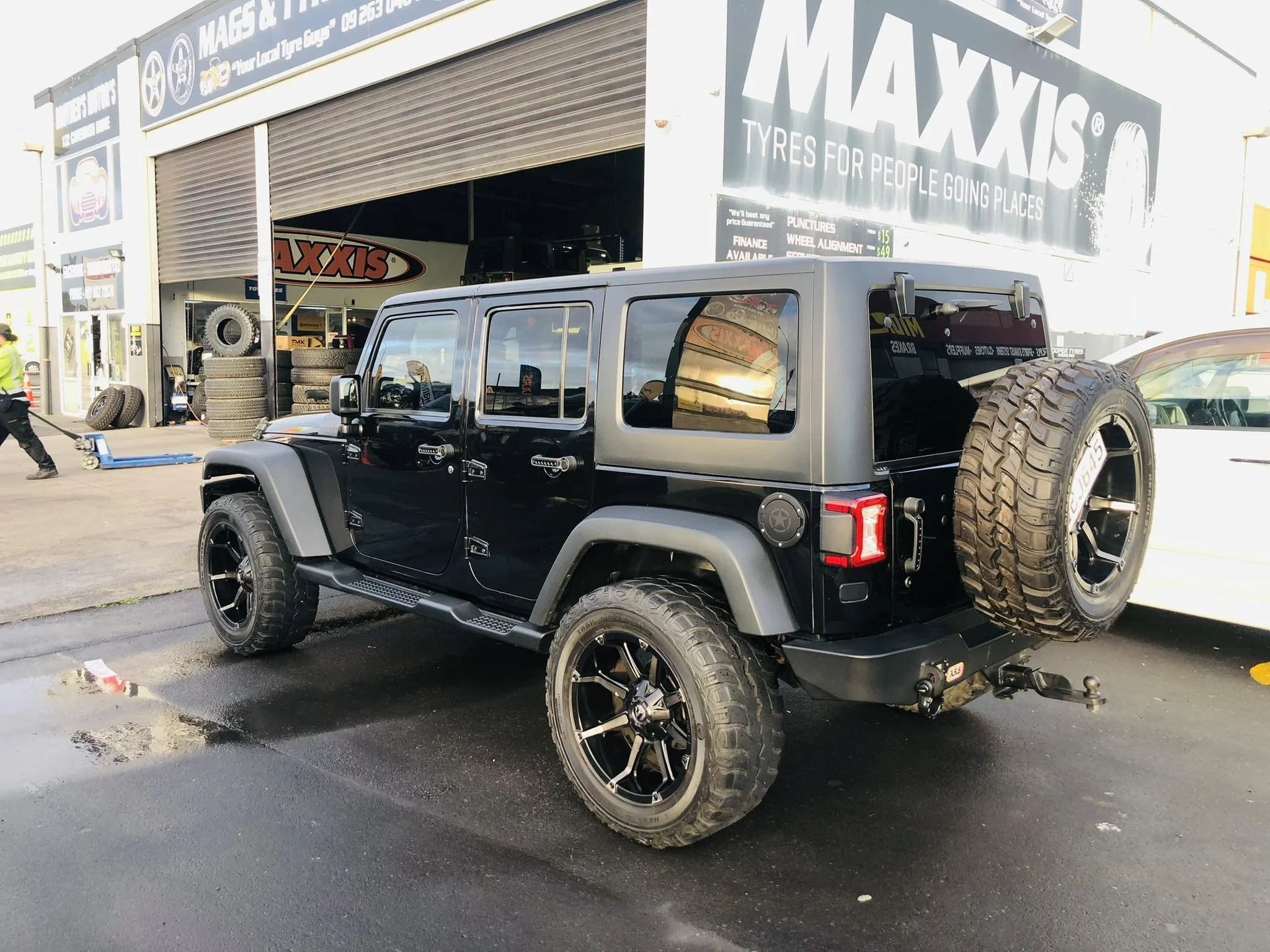Black Jeep with spotless paint finish after professional car detailing by Dirt Devils Auto Valet