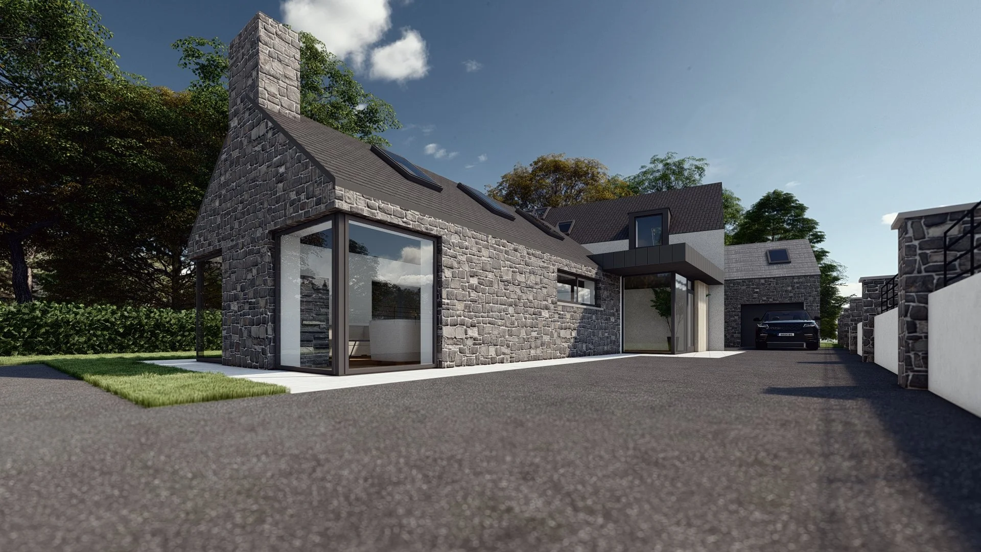 Front view of a modern house with stone walls, large windows, a driveway, and a garage with a car inside. Trees and a blue sky with some clouds in the background.