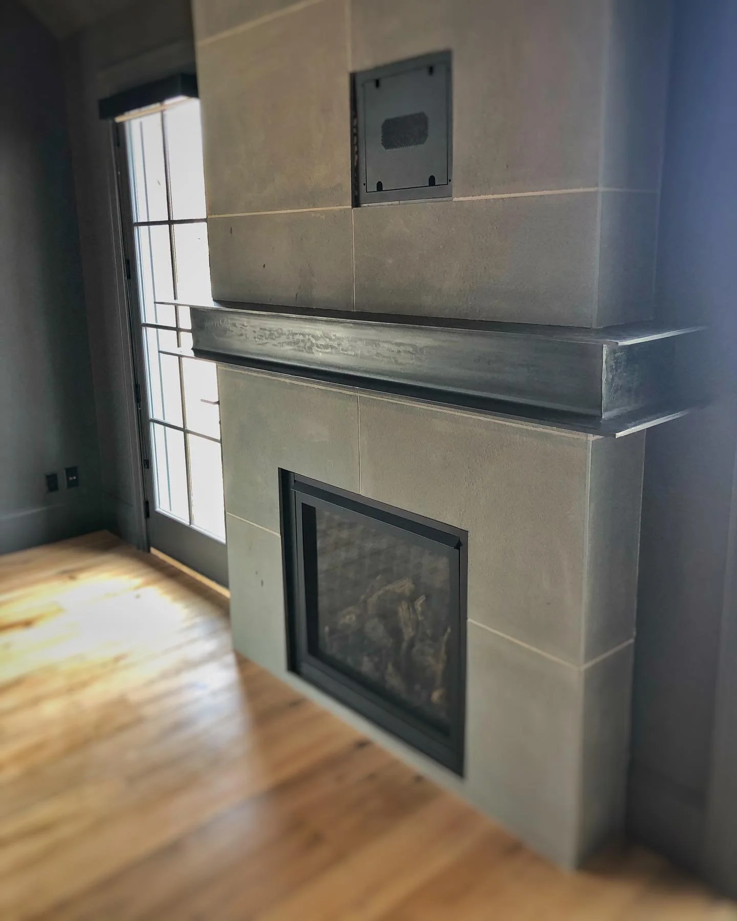 I beam fire place mantle with a black patina.