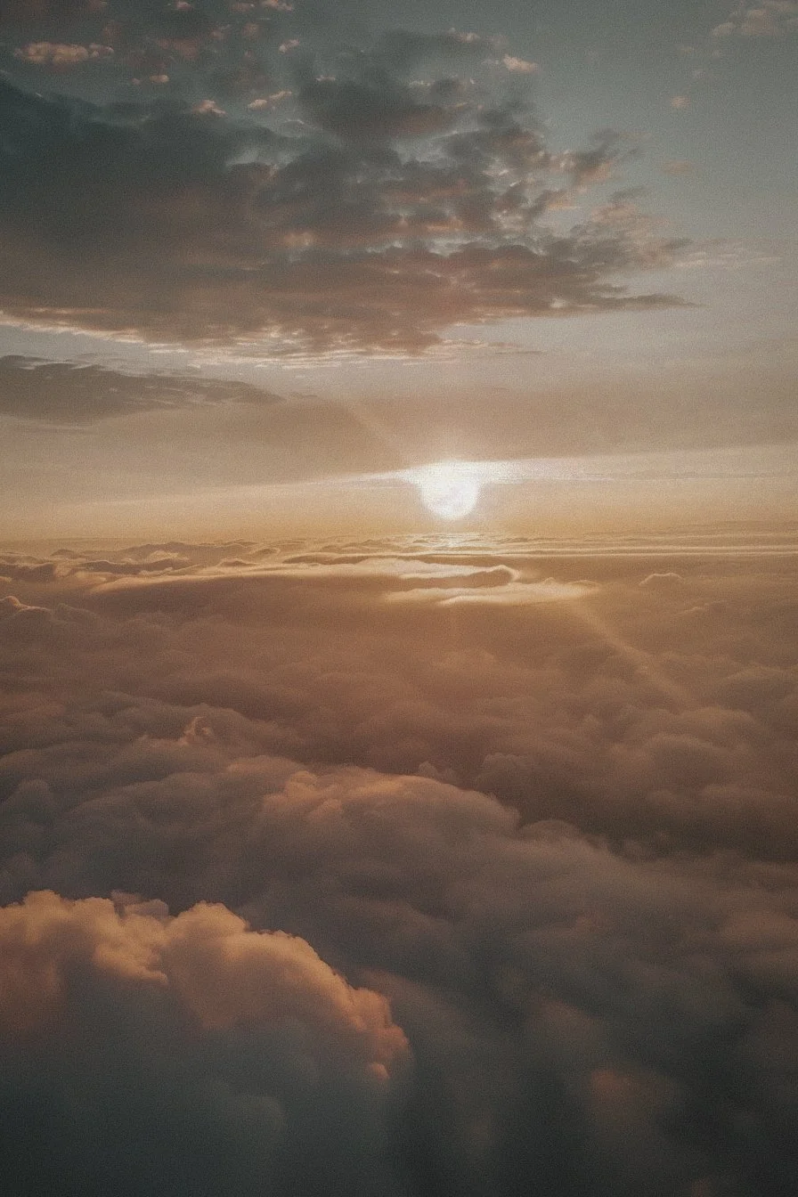 Sunlight breaking through clouds above the horizon representing clarity, reflection, and inner healing.