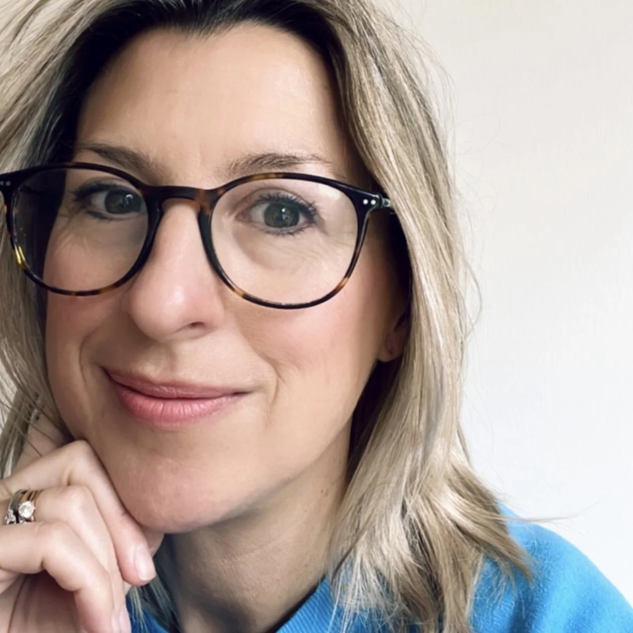 A picture of Amy Goodall, brand strategist and brand identity designer - looking directly at the camera and smiling