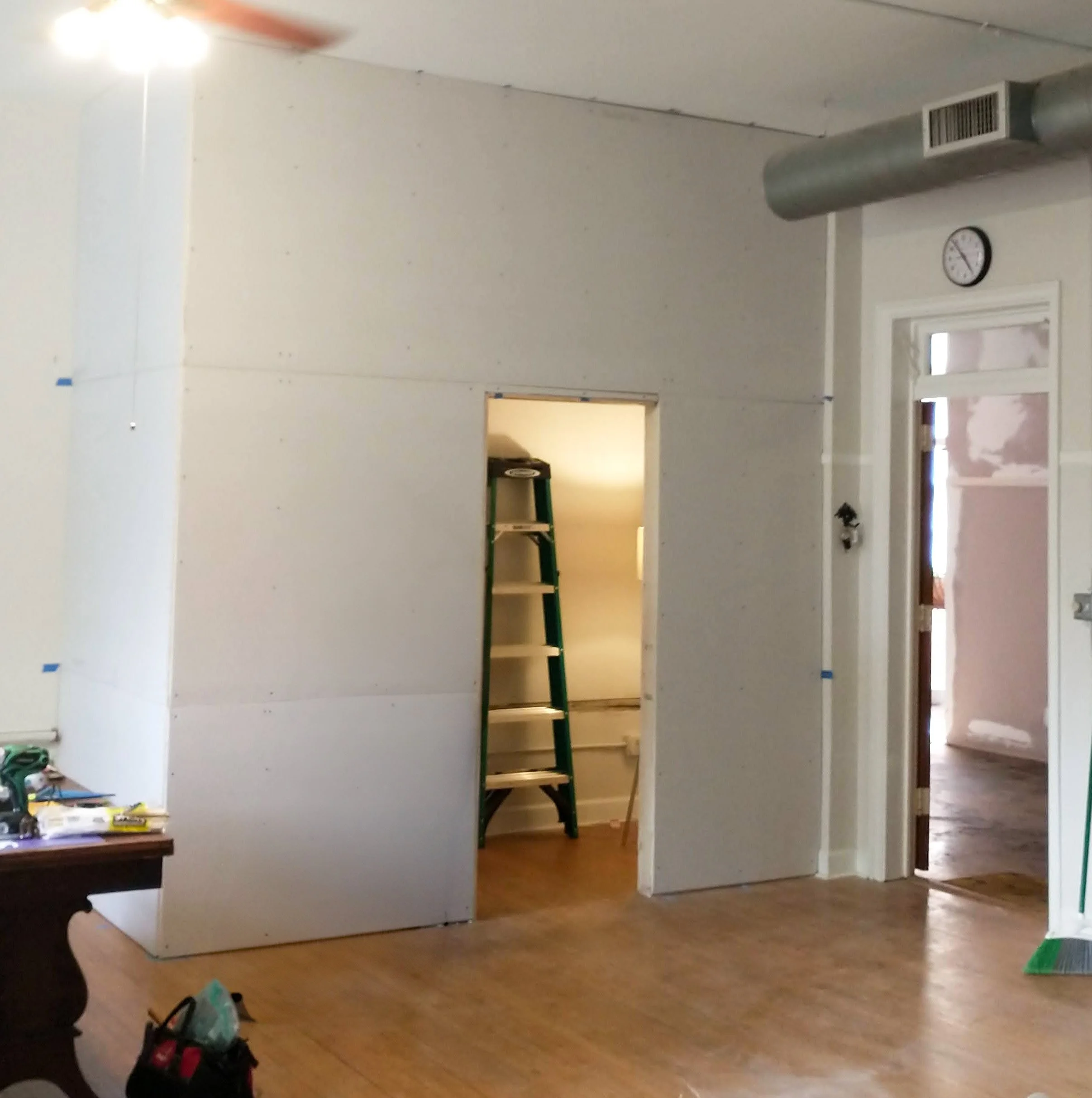 New closet space framed and drywalled with pocket door