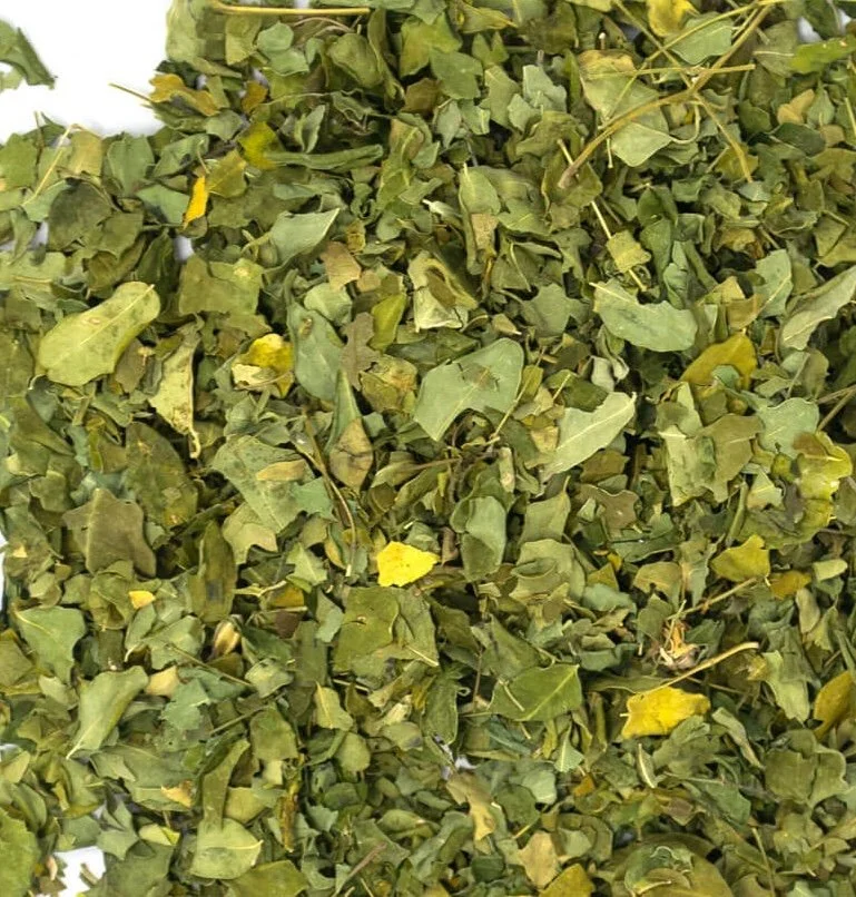 Dried chopped green leaves, likely herbs.