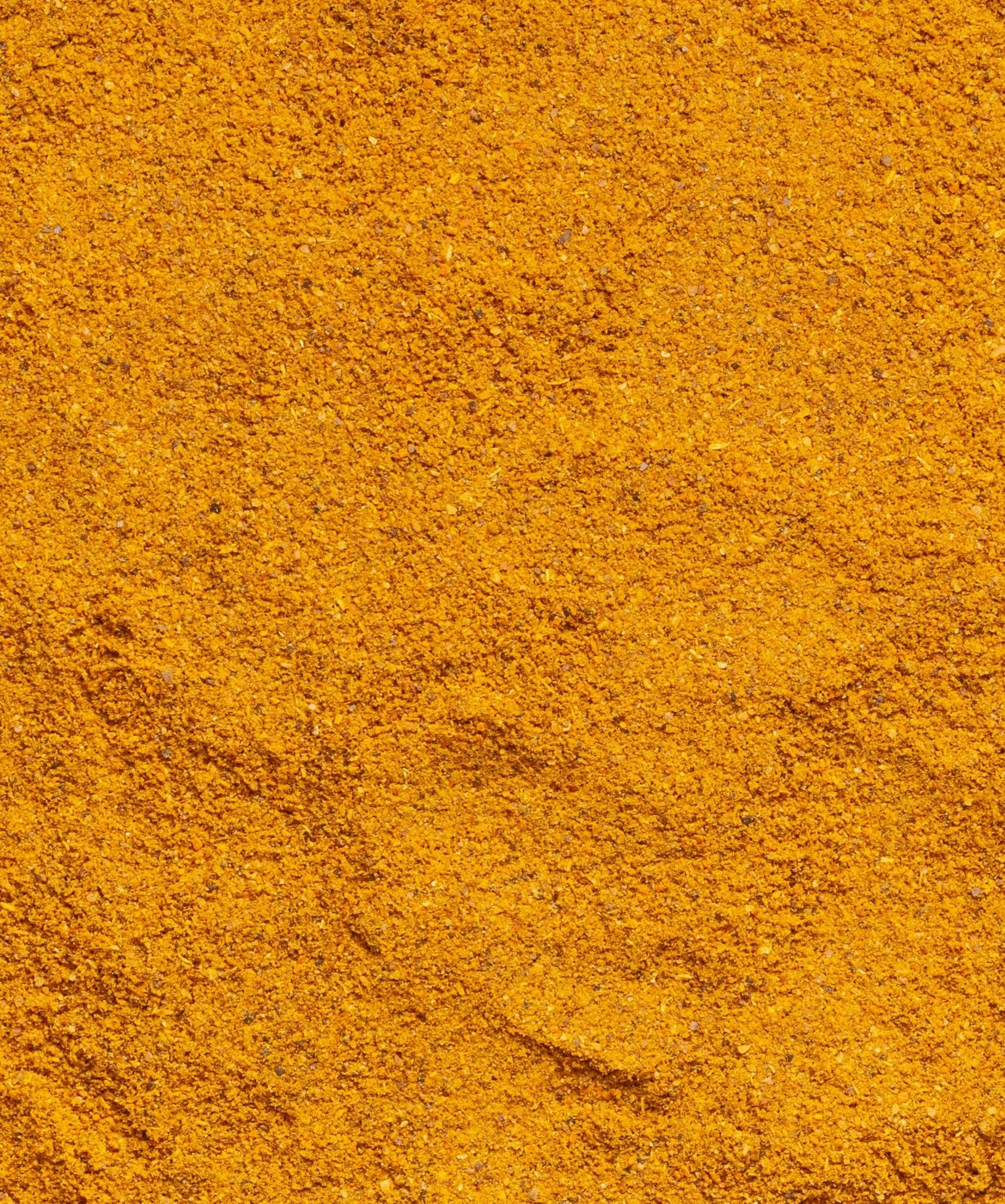 Close-up of tumeric with a rough texture and small grains.