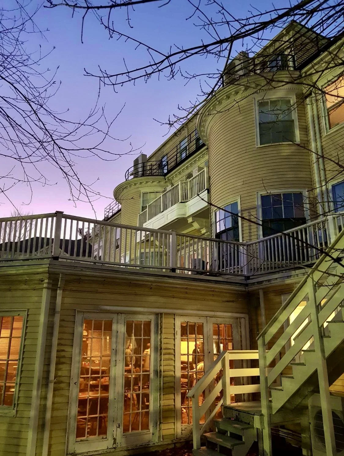 large roof repair project on yellow Victorian