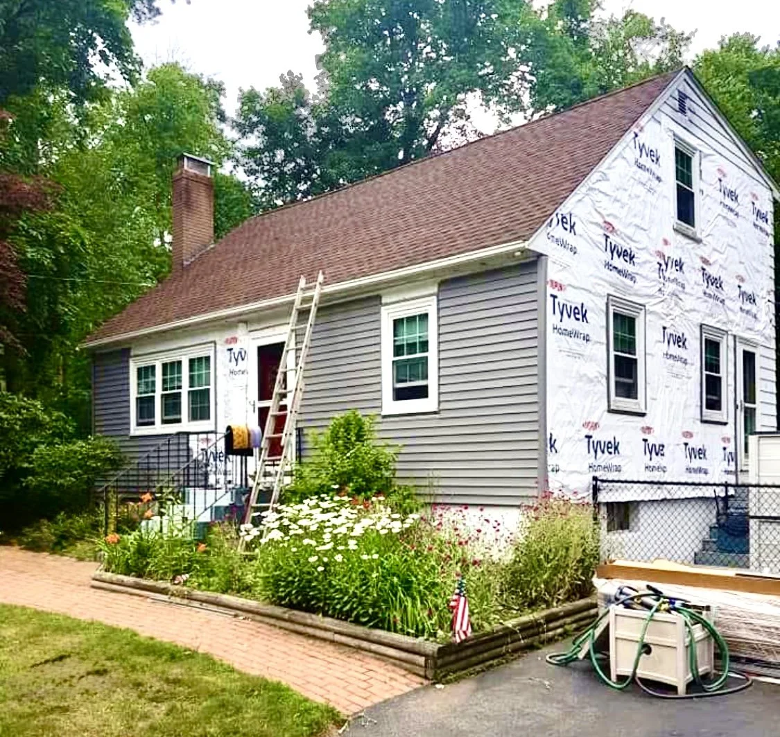 A Signature Renovation Group project featuring vinyl siding replacement for a small Cape house in Rhode Island