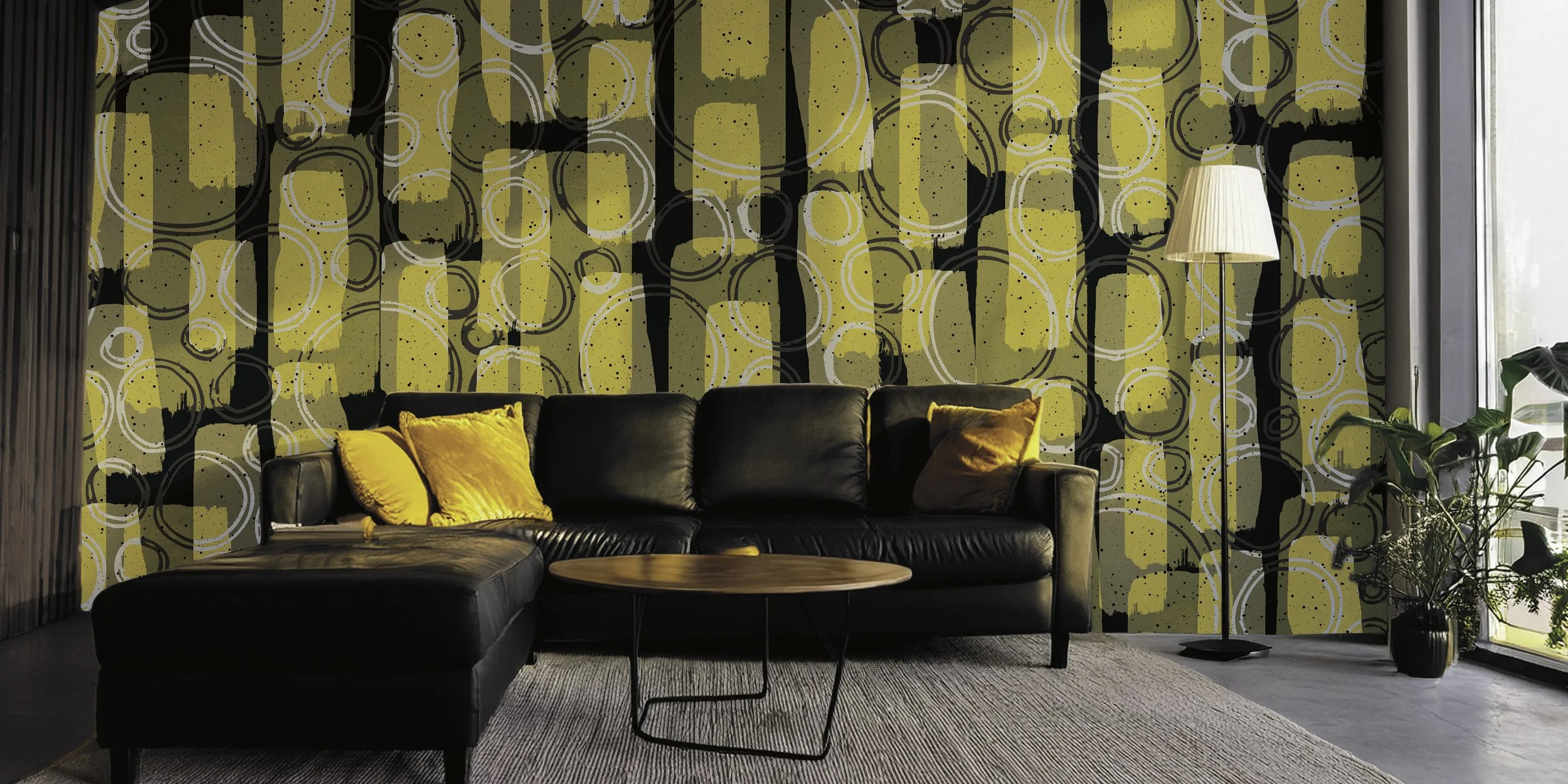 Modern living room with a black leather sofa adorned with yellow pillows, a wooden coffee table, a tall floor lamp, and a large window. The wall features a yellow, black, and white abstract circular pattern.