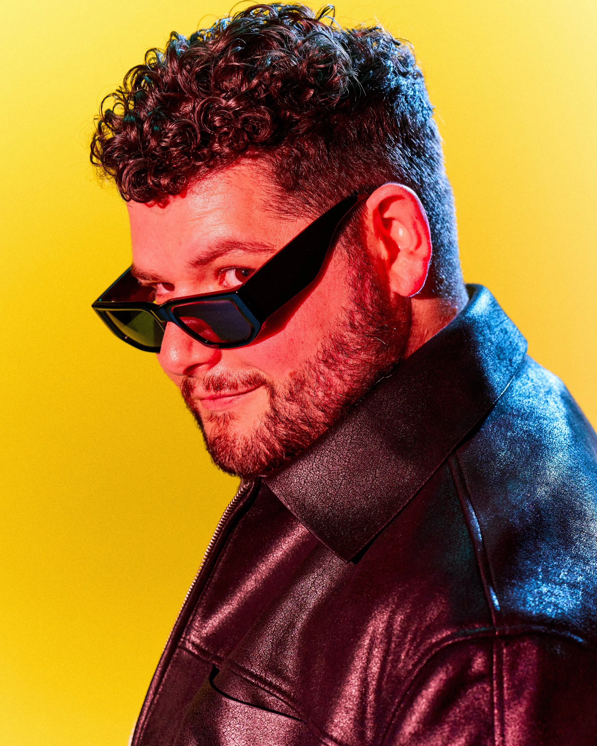 Edgy character actor portrait of Nicholas Molencupp in a leather jacket with dramatic neon lighting