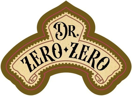 Logo with the words 'Zero Zero' in a stylized font on a beige background with an ornate border, shaped like a shield. Available at Neer Beer Beverage Company