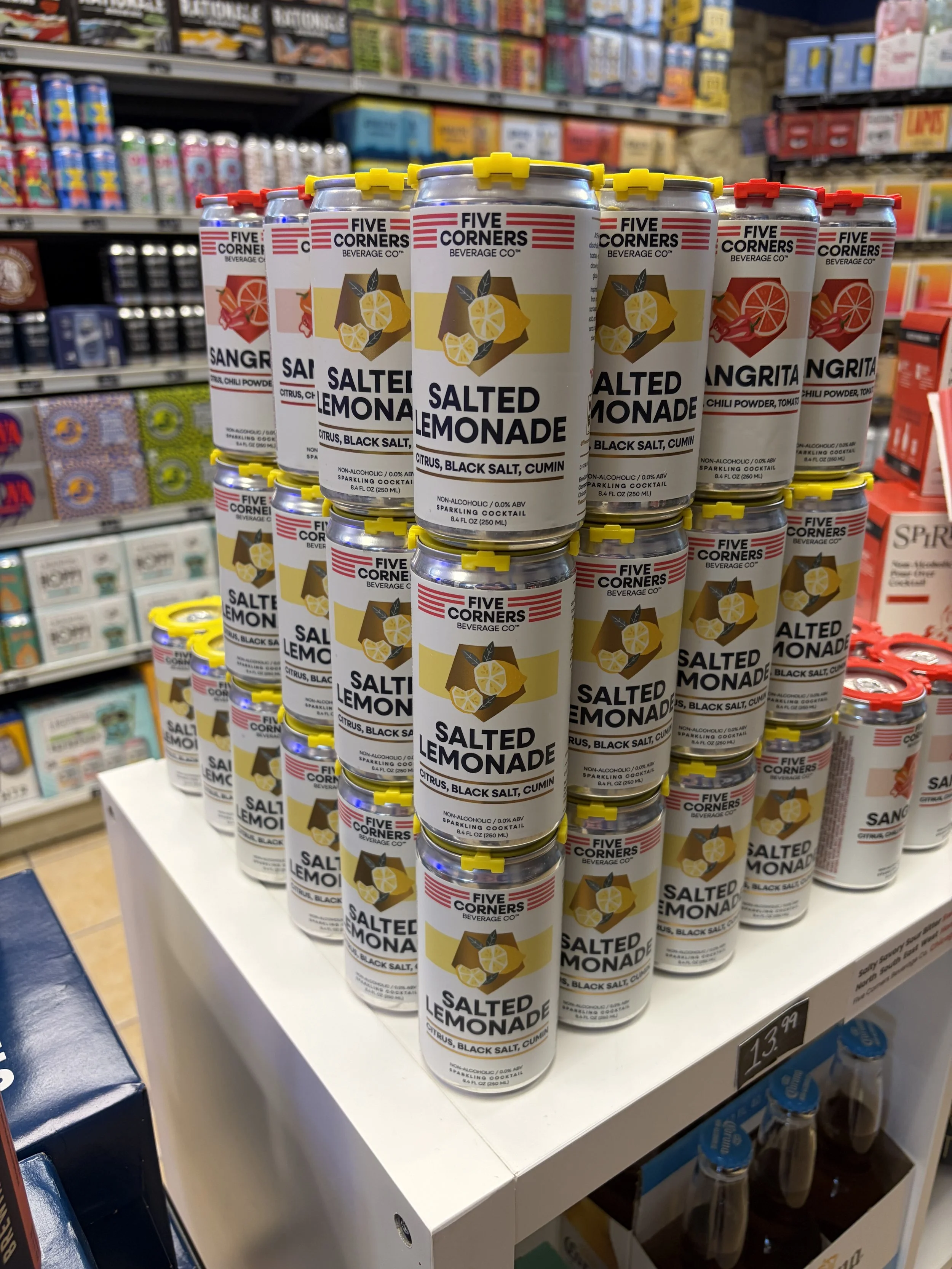 Cans of non-alcoholic salted lemonade with citrus, black salt, and cumin flavor on display in a store in downtown wheaton Illinois.