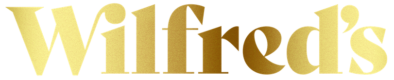 Gold shimmery gradient text spelling 'Wilfred's' Non-Alcoholic Beverages Available at Neer Beer Beverage Company