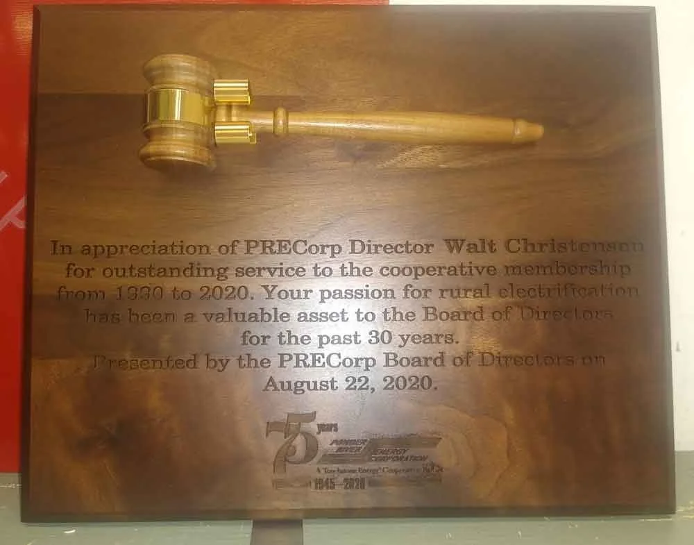 Wooden plaque with a gold gavel mounted at the top and an engraved message honoring Walt Christenson for his service to PRECorp from 1930 to 2020, presented on August 22, 2020.
